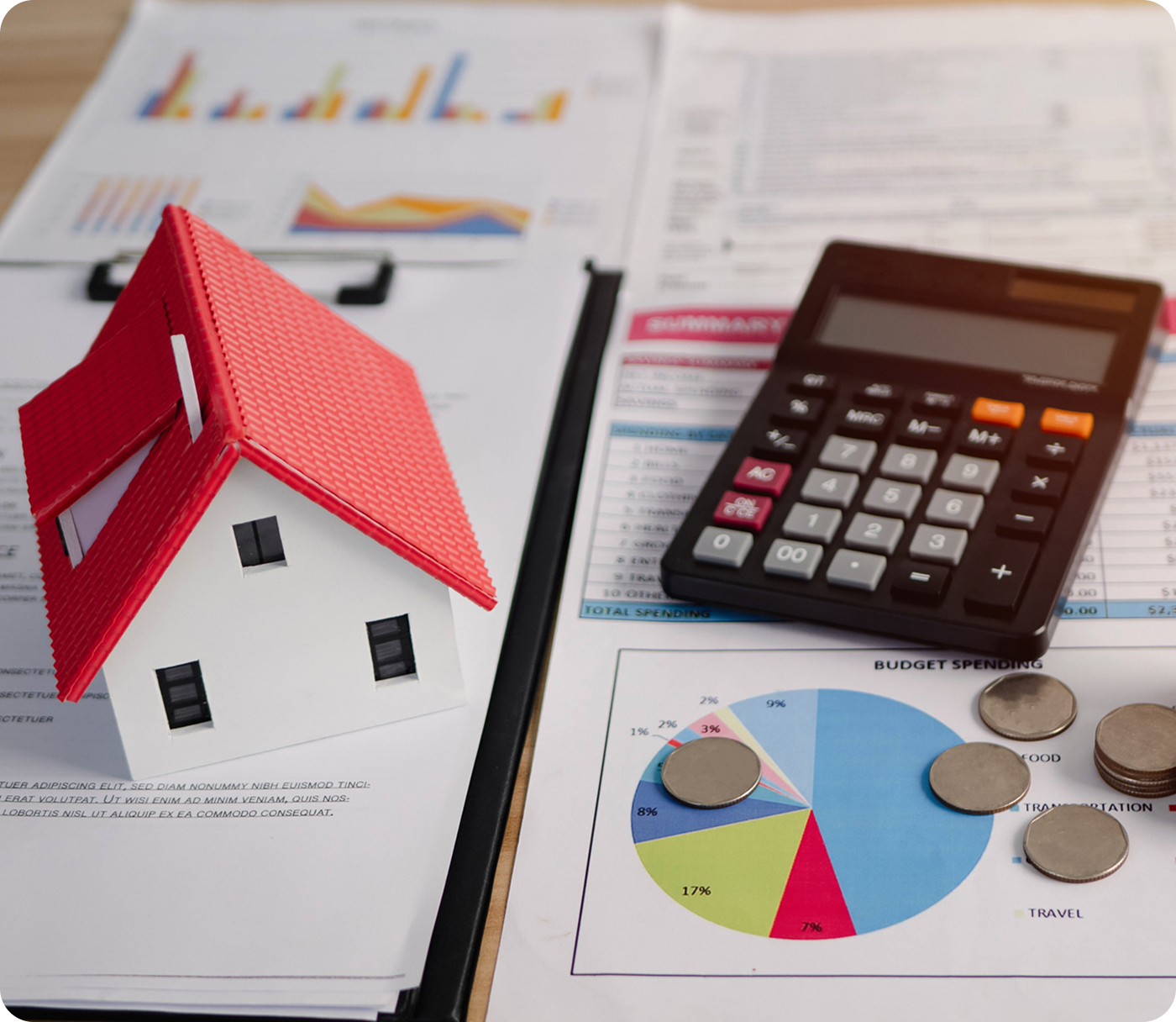 Model house, calculator, charts, and coins.