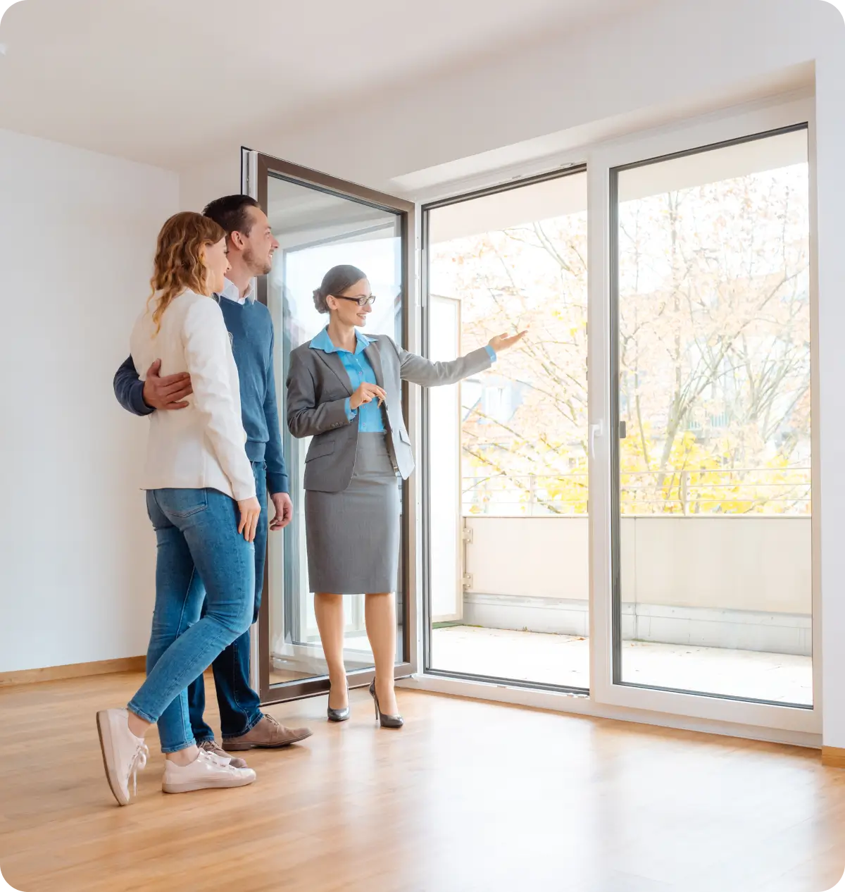 Couple viewing apartment with real estate agent.