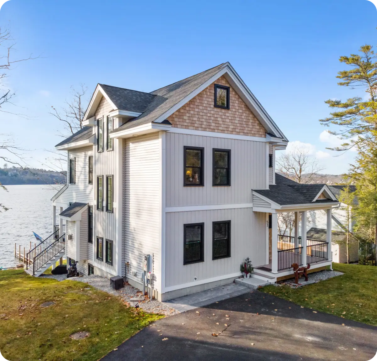 Lakeside house with a large porch.